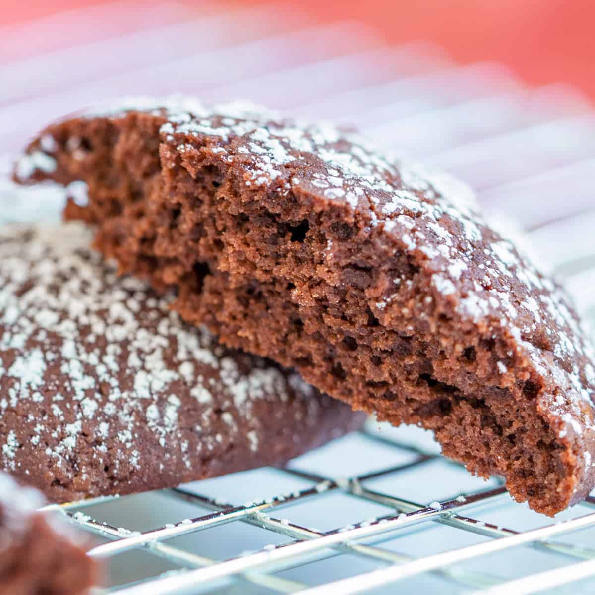 Half a chocolate cream cheese cookie on a wire rack.