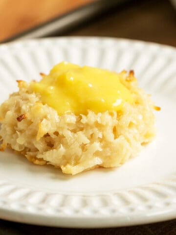 Creamy coconut pineapple macaroon on a white plate.