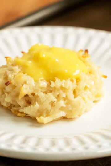 Creamy coconut pineapple macaroon on a white plate.