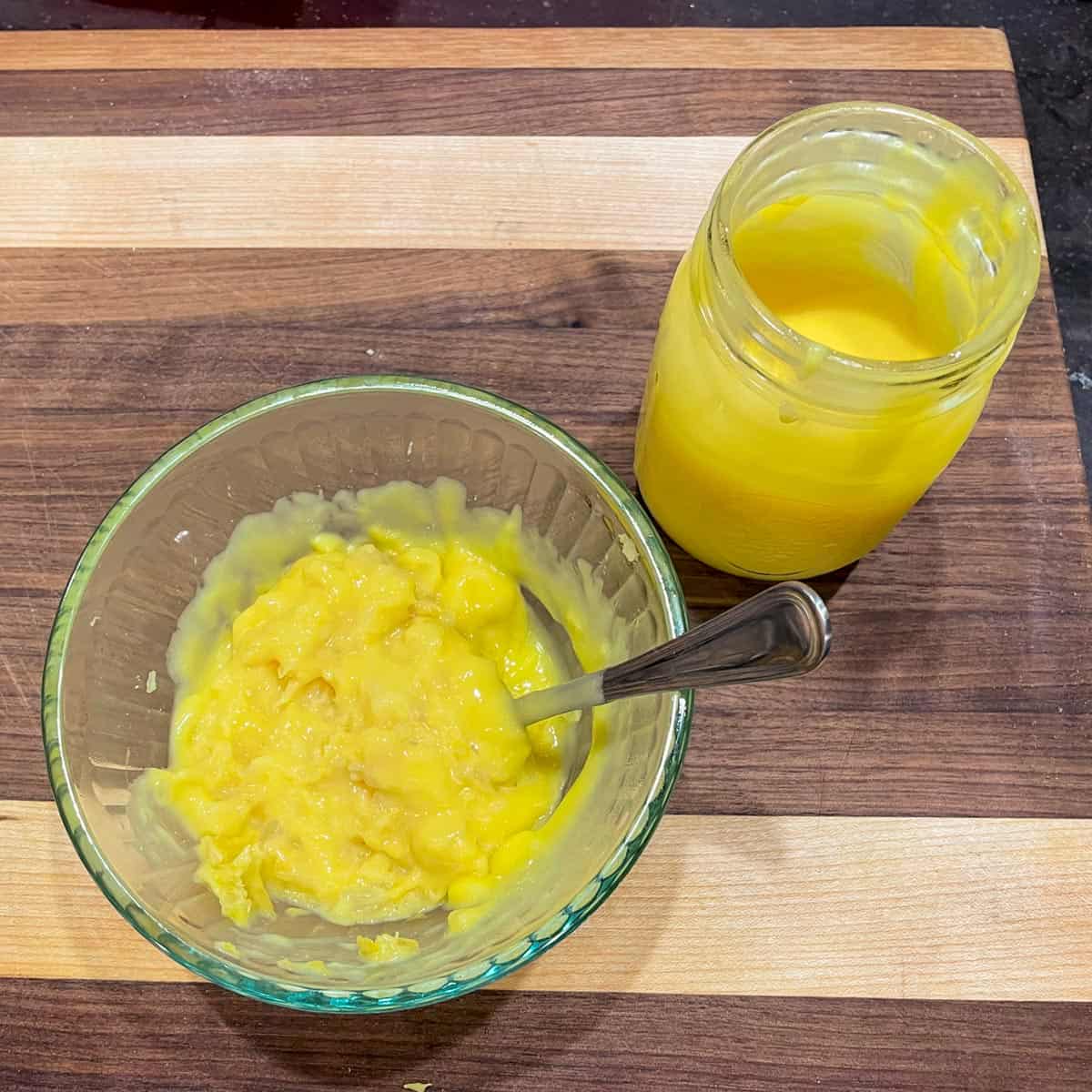 Pineapple curd mixed with crushed pineapple in a glass bowl.