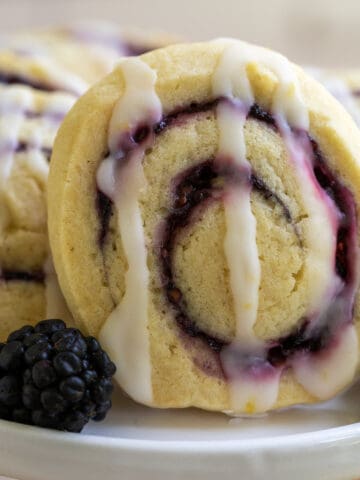 Cookie with blackberry filling swirl on a white platter.