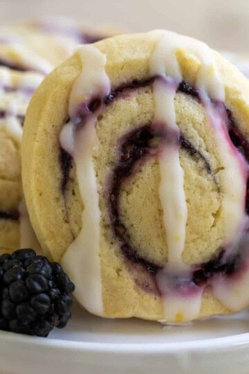 Cookie with blackberry filling swirl on a white platter.
