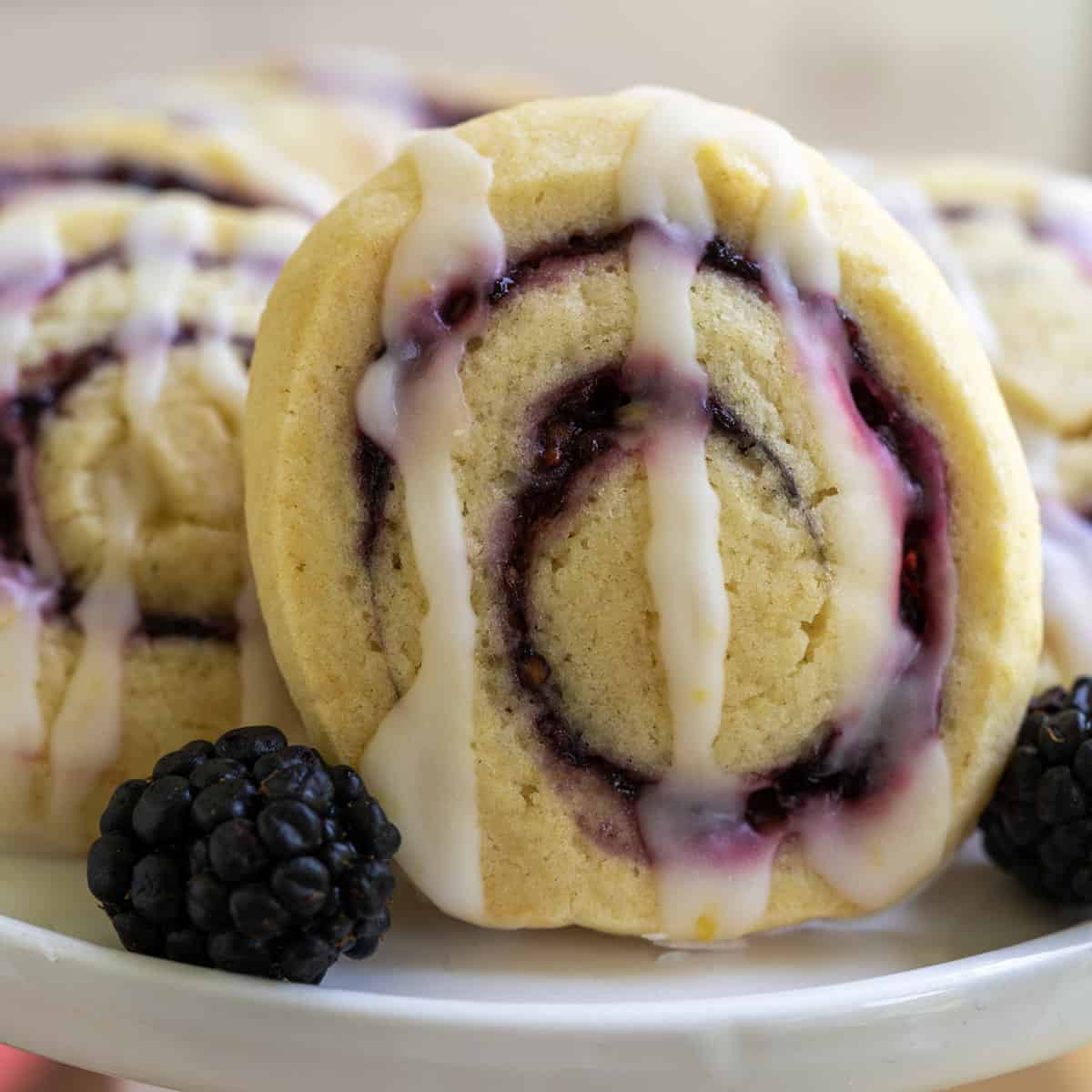 Cookie with blackberry filling swirl on a white platter.