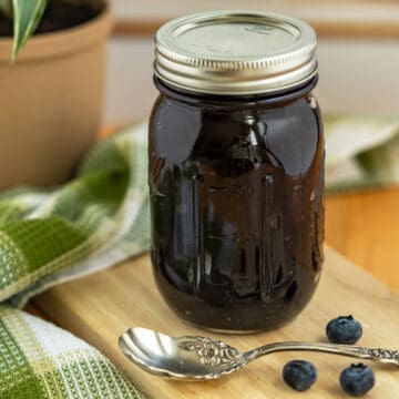 Blueberry Filling with spoon on wooden plank.