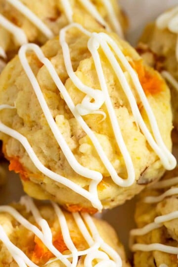 Plate full of apricot with almonds cookies, with plenty of white chocolate icing.