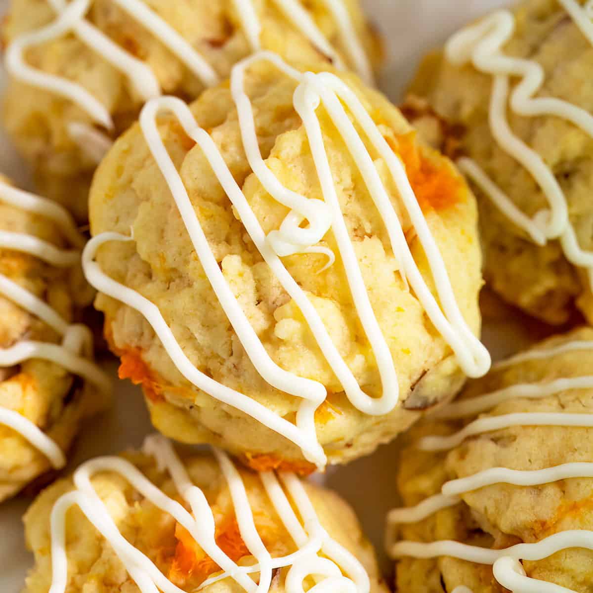 Plate full of apricot with almonds cookies, with plenty of white chocolate icing.