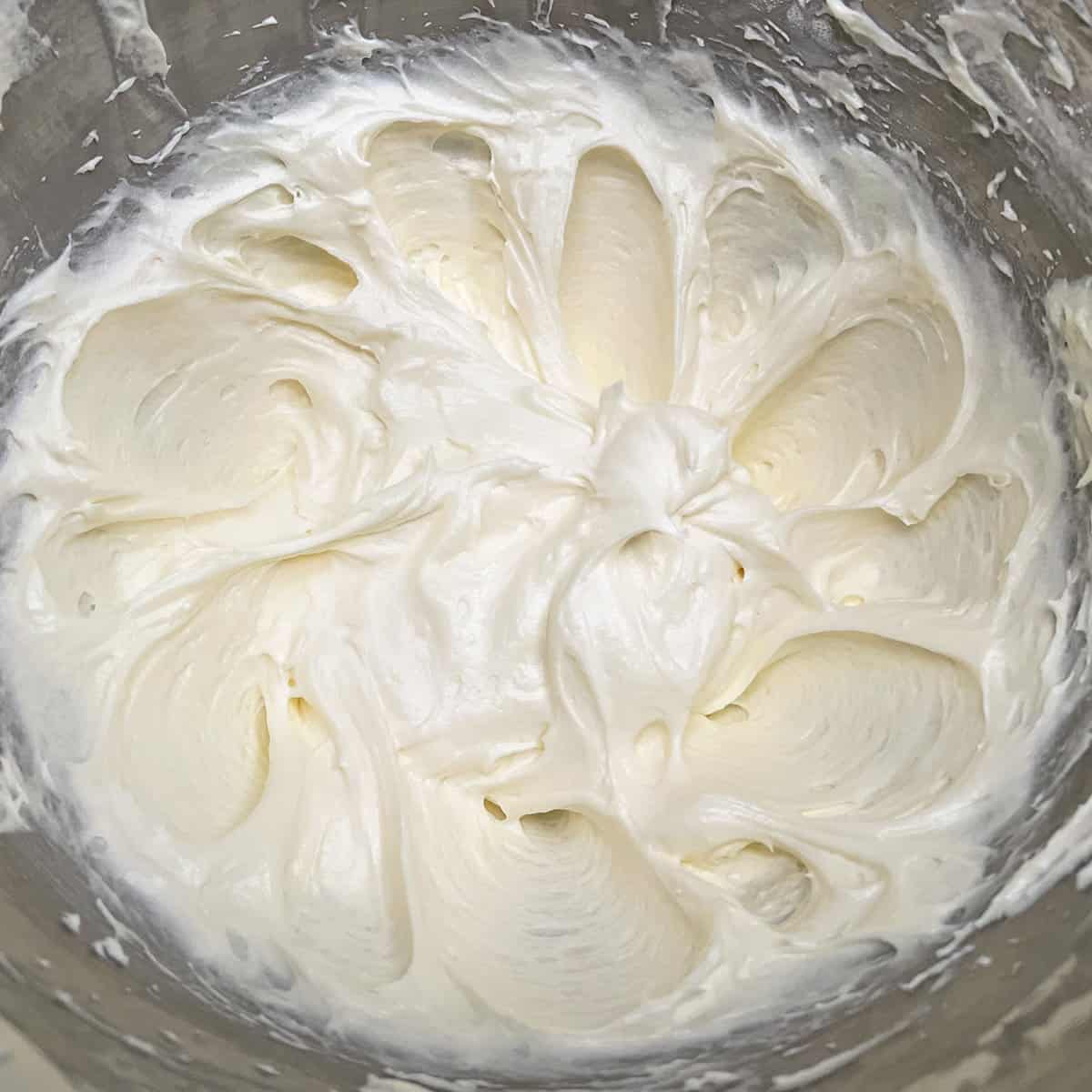 Maple cream cheese frosting in a mixer bowl.