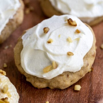 Banana Cookie with frosting and walnuts on top.