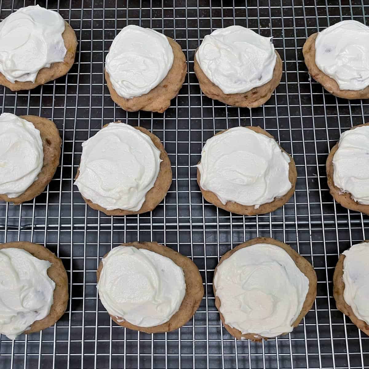 Banana cookies on a wire rack and just had white frosting put on top. 