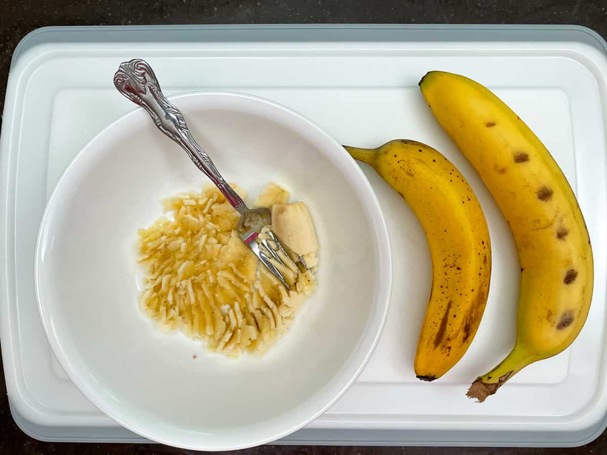 Mashing bananas with a fork.