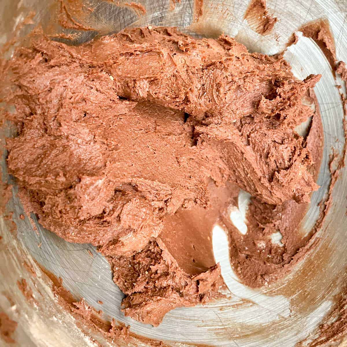 Chocolate cookie dough in a mixer bowl.