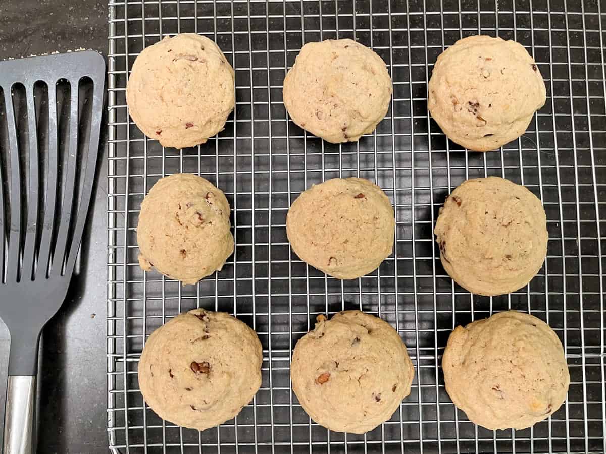 Finished cookies on a cooling rack with spatula.