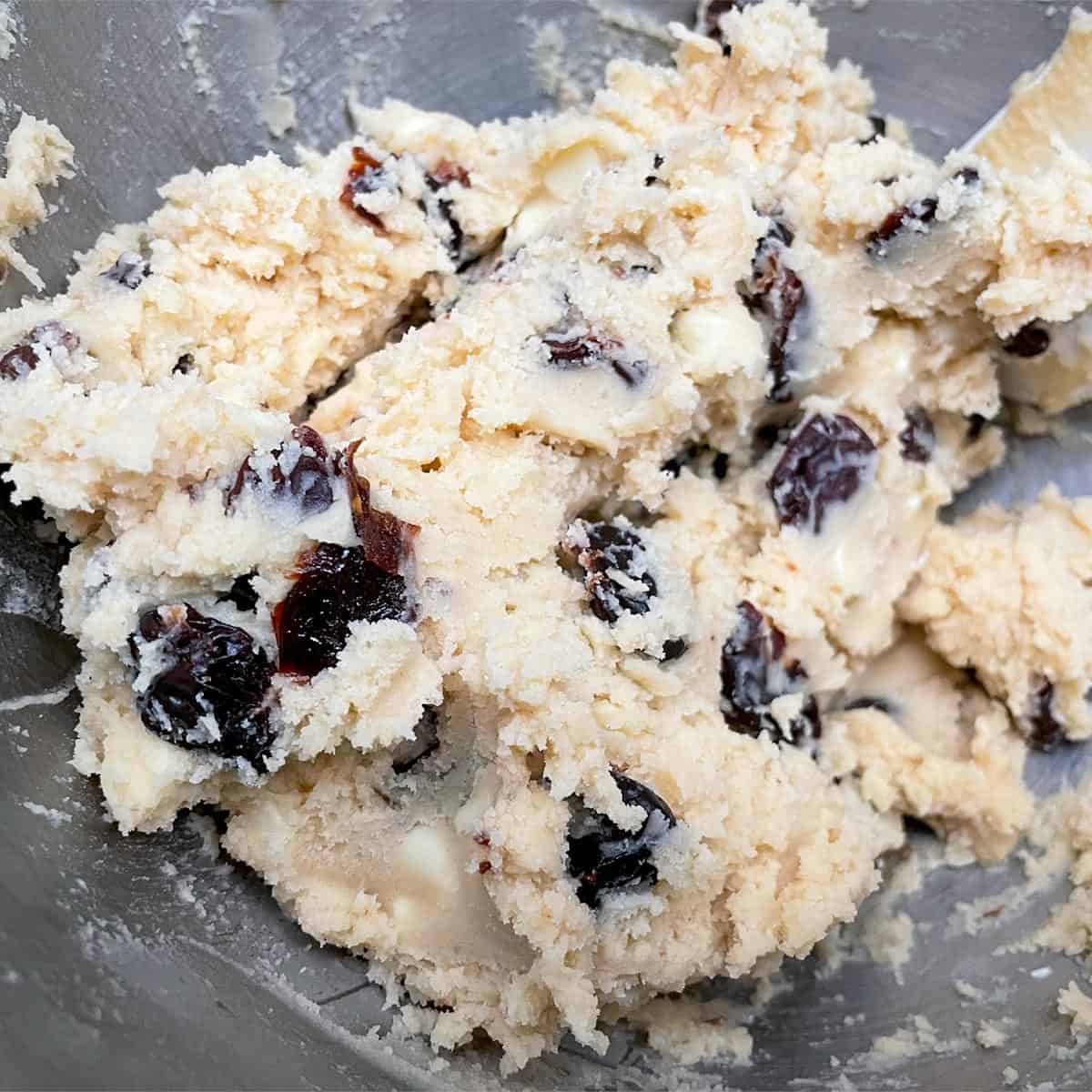 All ingredients mixed together in a mixer bowl for the sweet cherries and white chocolate cookies.