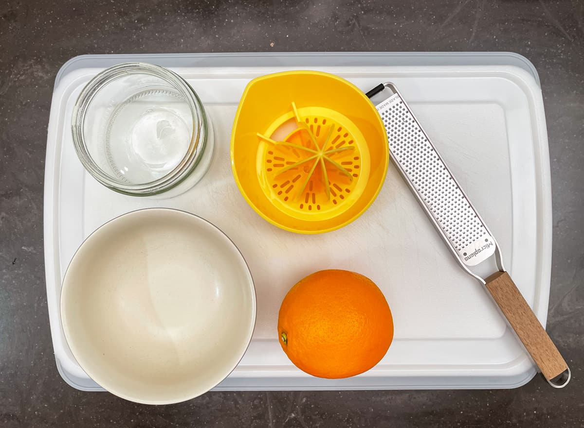 What you need to zest and juice an orange, a bowl, zester, and juicer.