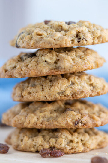 Stack of Spiced Oatmeal Raisin cookies with a blue and white napkin behind the stack.