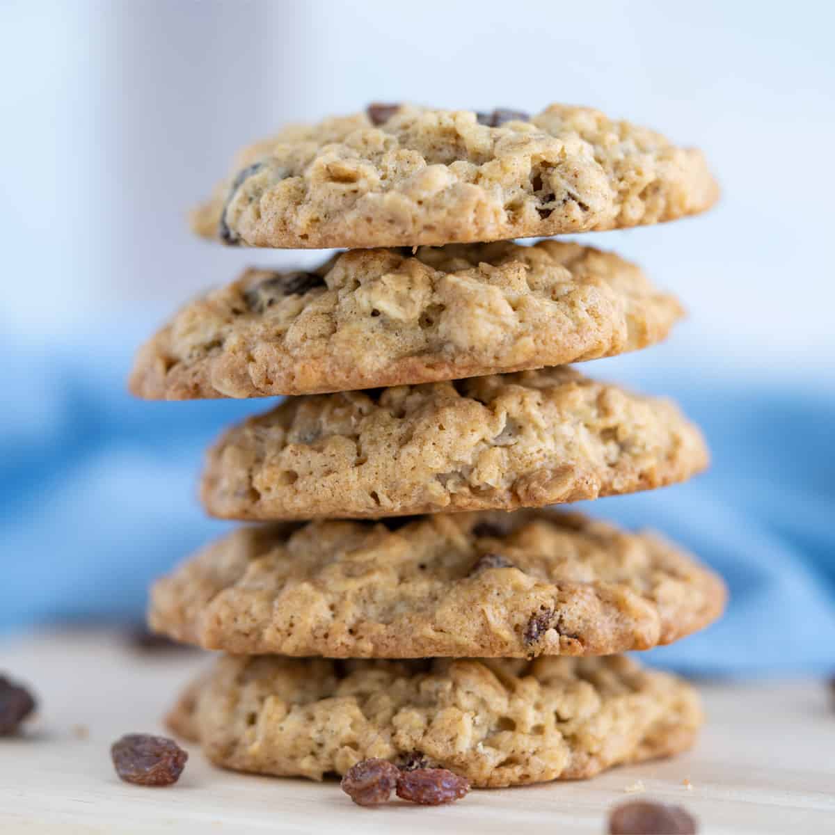 Stack of Oatmeal cookies with a blue and white napkin behind the stack.