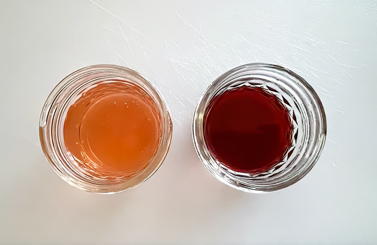 2 jars of champagne one is right out of the bottle and a rose color, the other is a dark deep red champagne reduction.