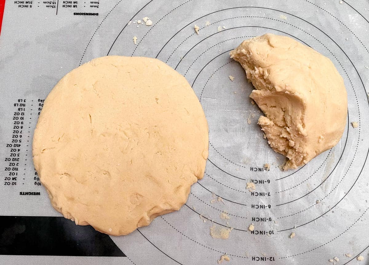 Cookie dough split in half and on half is flattened and shaped into a disk.