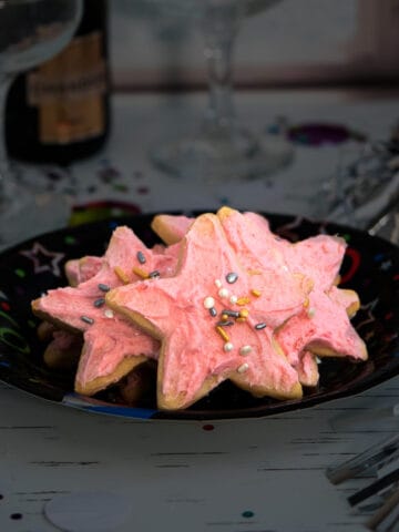 Champagne Cookies with Raspberry Buttercream Frosting on a New Year's Eve plate.