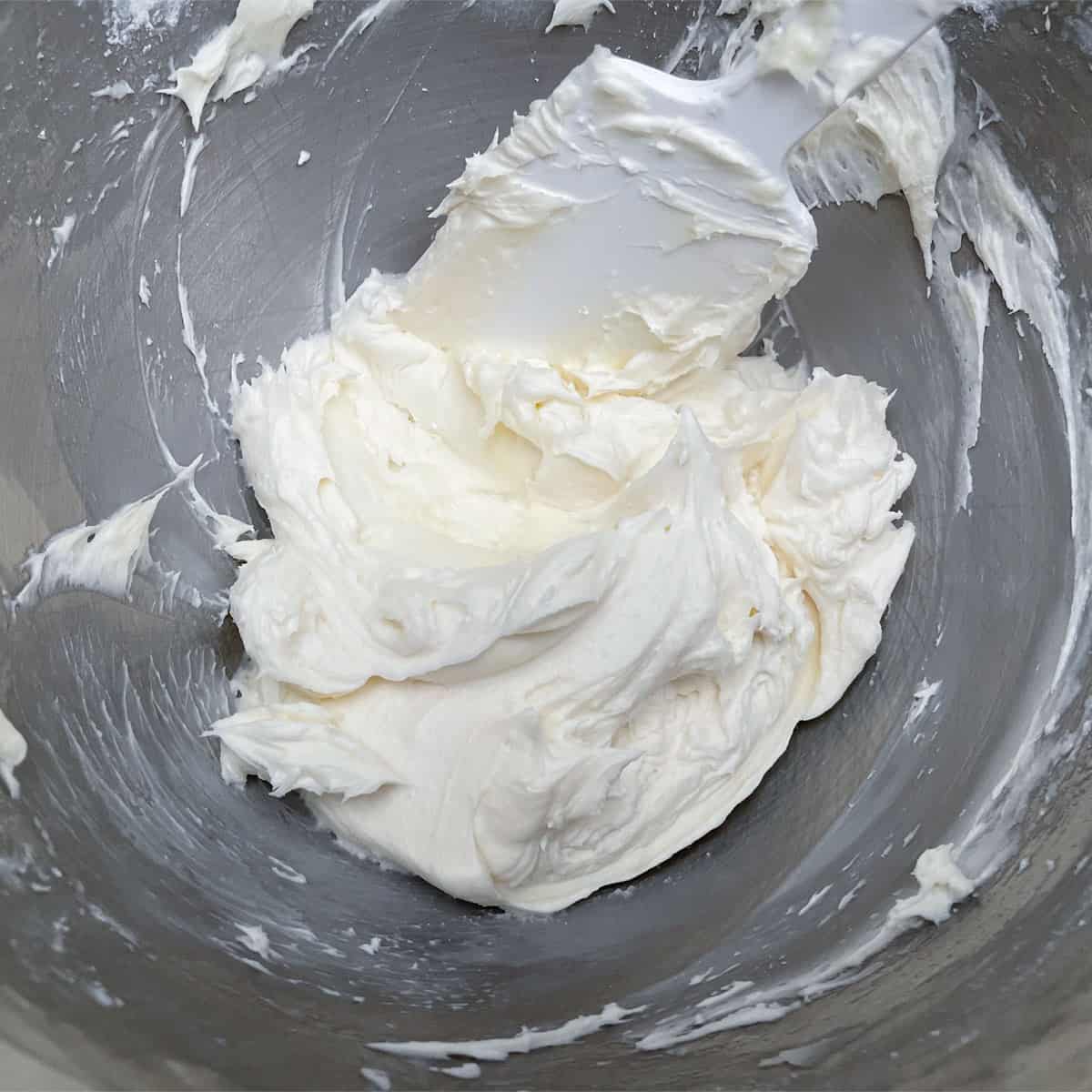 Coconut buttercream frosting in the mixer bowl just before adding the sweetened coconut.
