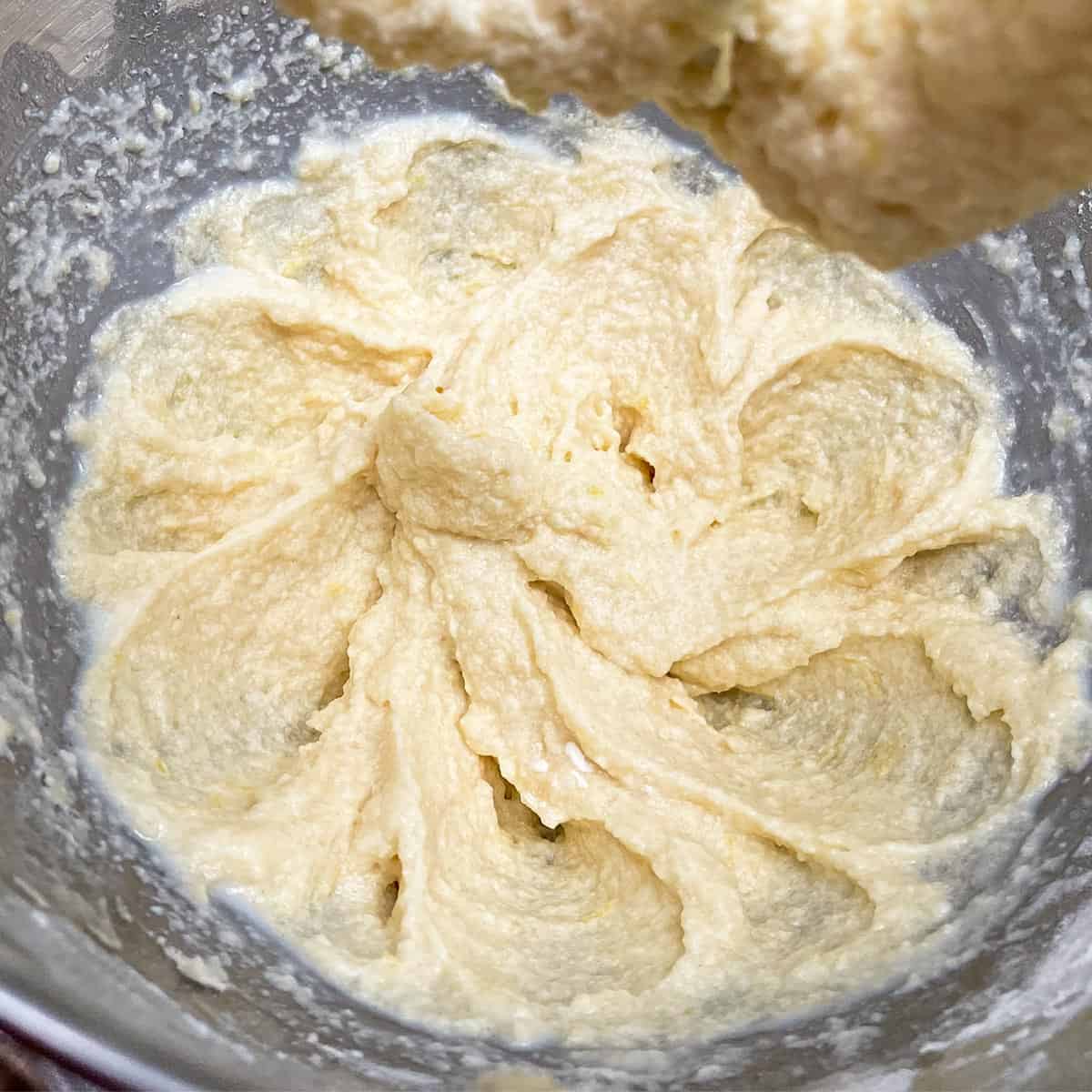 Cookie dough before adding flour, bits of lemon zest all through the mixture.