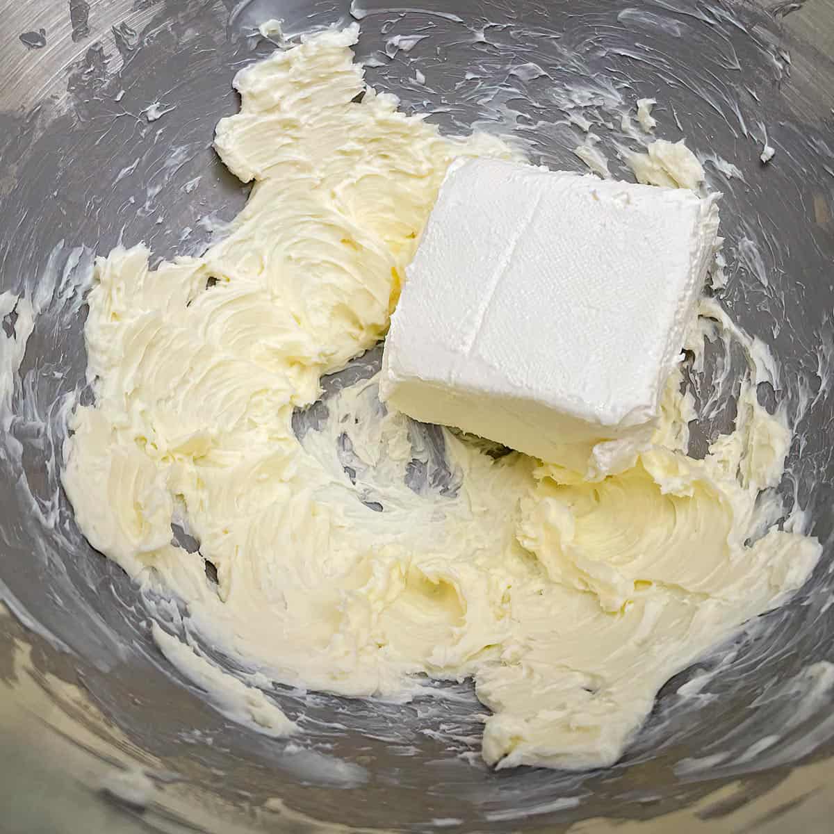 Mixing the butter before adding the cream cheese.