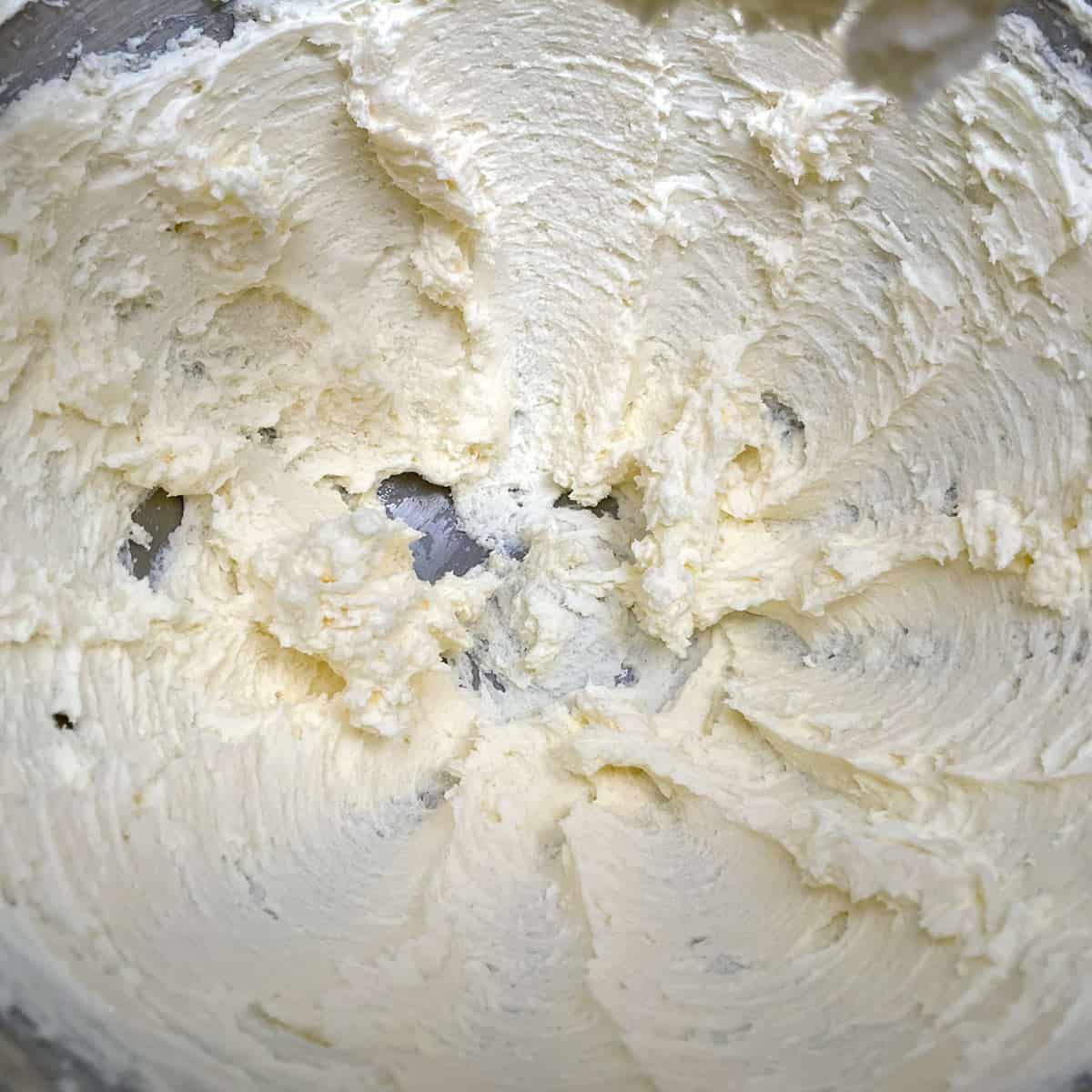 Cream cheese and butter after it has been mixed for 2 minutes.
