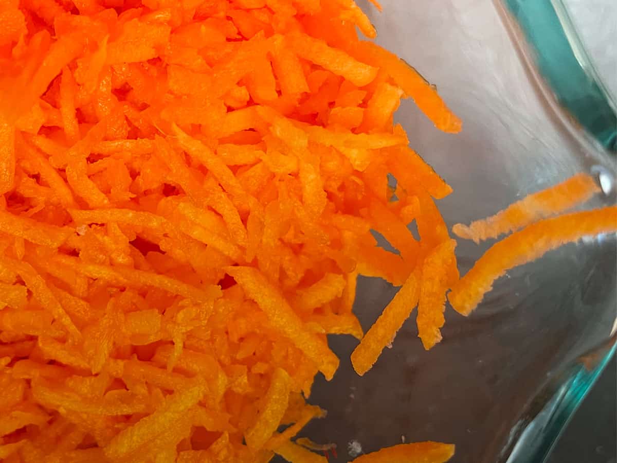 Shredded carrots that are small and paper thin.