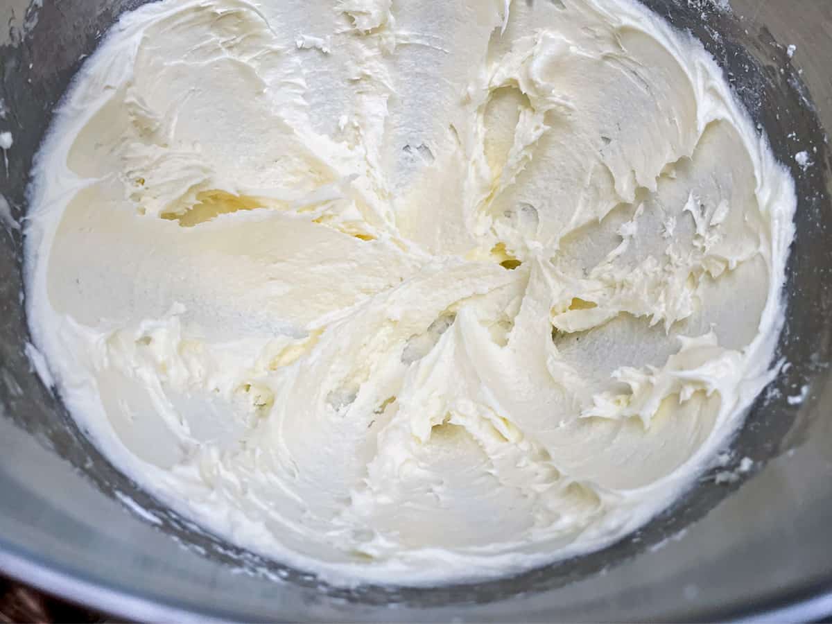 Butter and cream cheese mixed in a mixer bowl.