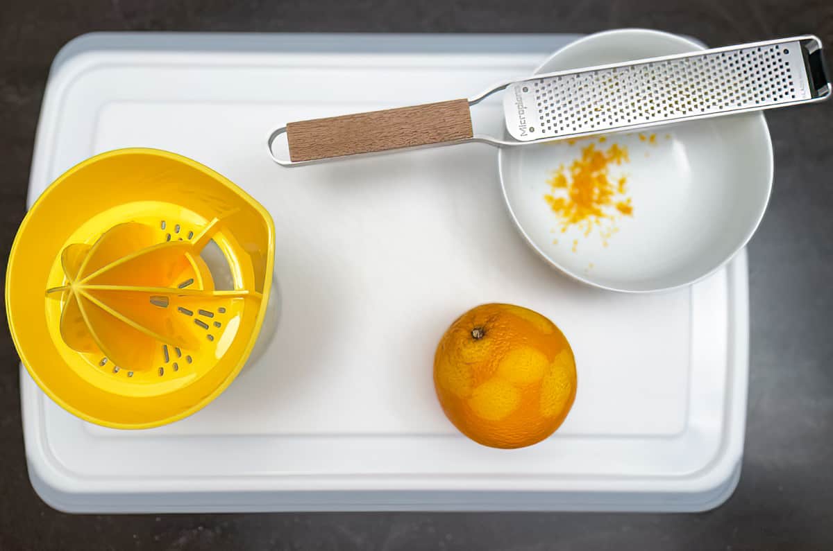 juice and zest an orange on a cutting board.
