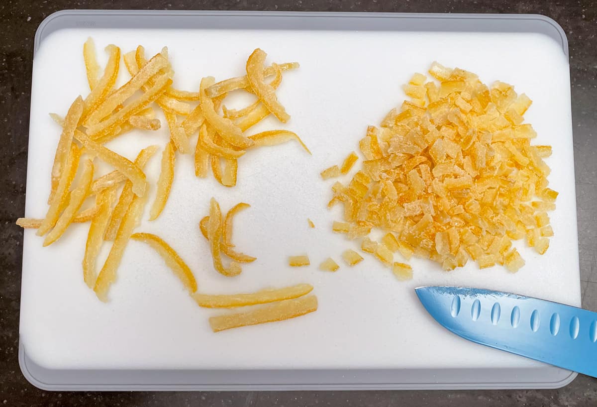 Lemon peel strips being cut into small pieces.
