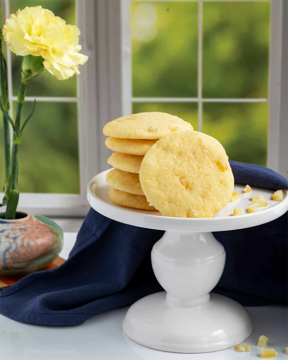 Lemon with a touch of honey cookies stacked on a pedestal dish.