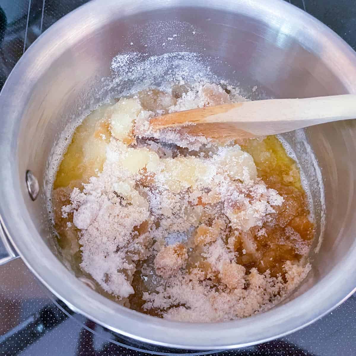 Adding the sugars to a pan of finished brown butter.