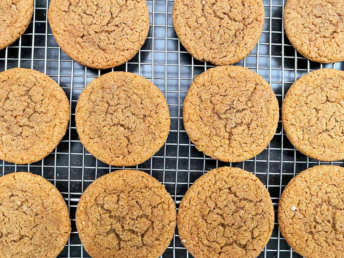 Ginger cookies on a cooling rack after baking.