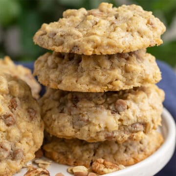 Caramel and oats cookies with pecan on a white plate.