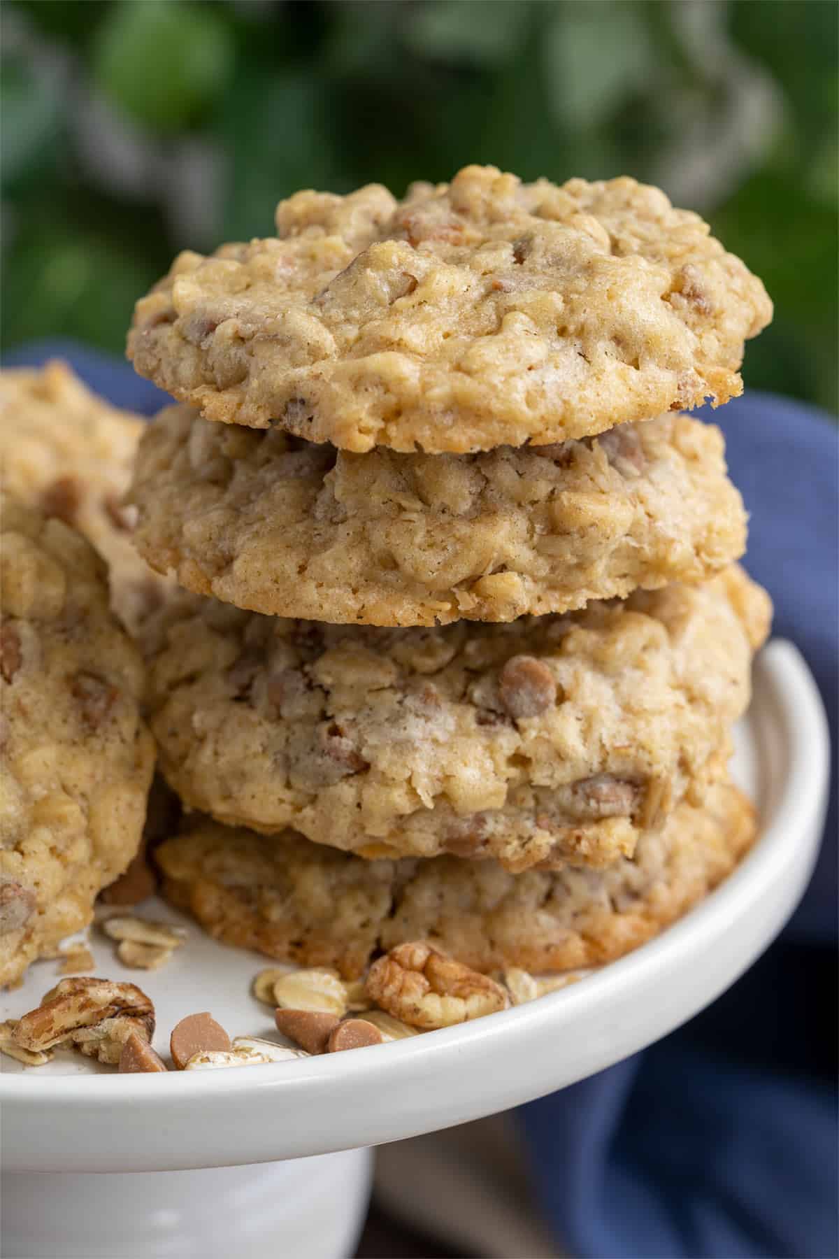 Stack of oatmeal cookies on a white plate.