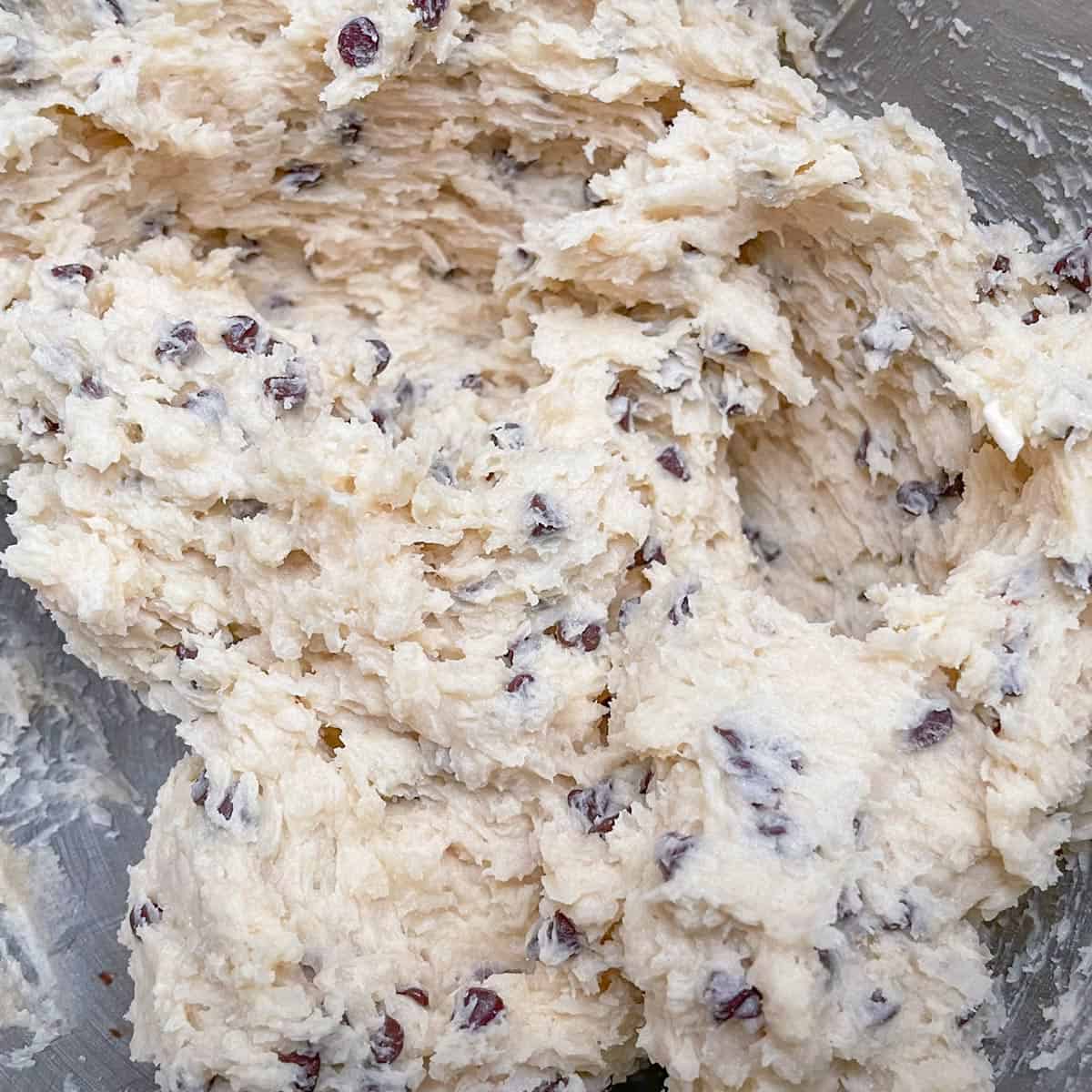 Coconut, almonds, and chocolate chips have been added to the cookie dough.