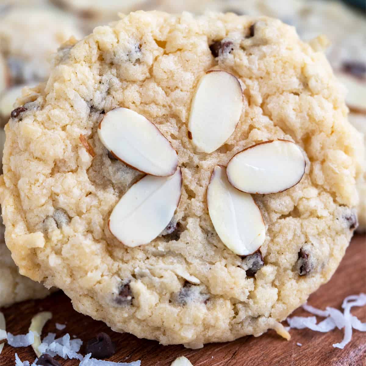 A close up of a coconut almond chocolate cream cheese cookie.