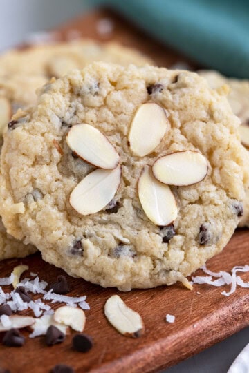A group of a coconut almond chocolate cream cheese cookie on a wooden board.