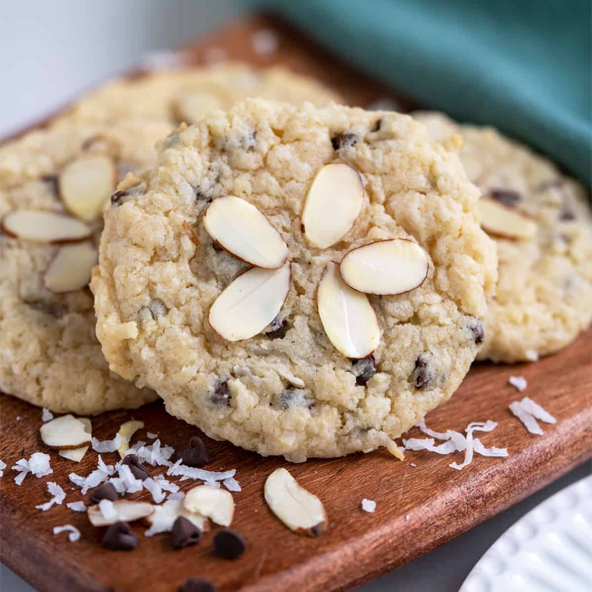 A group of a coconut almond chocolate cream cheese cookie on a wooden board.