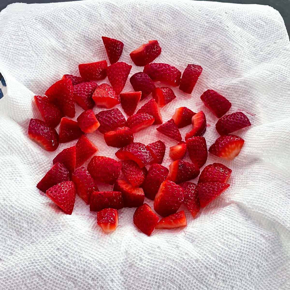 Cut up strawberries with cut side on paper towel to help absorb strawberries liquid.