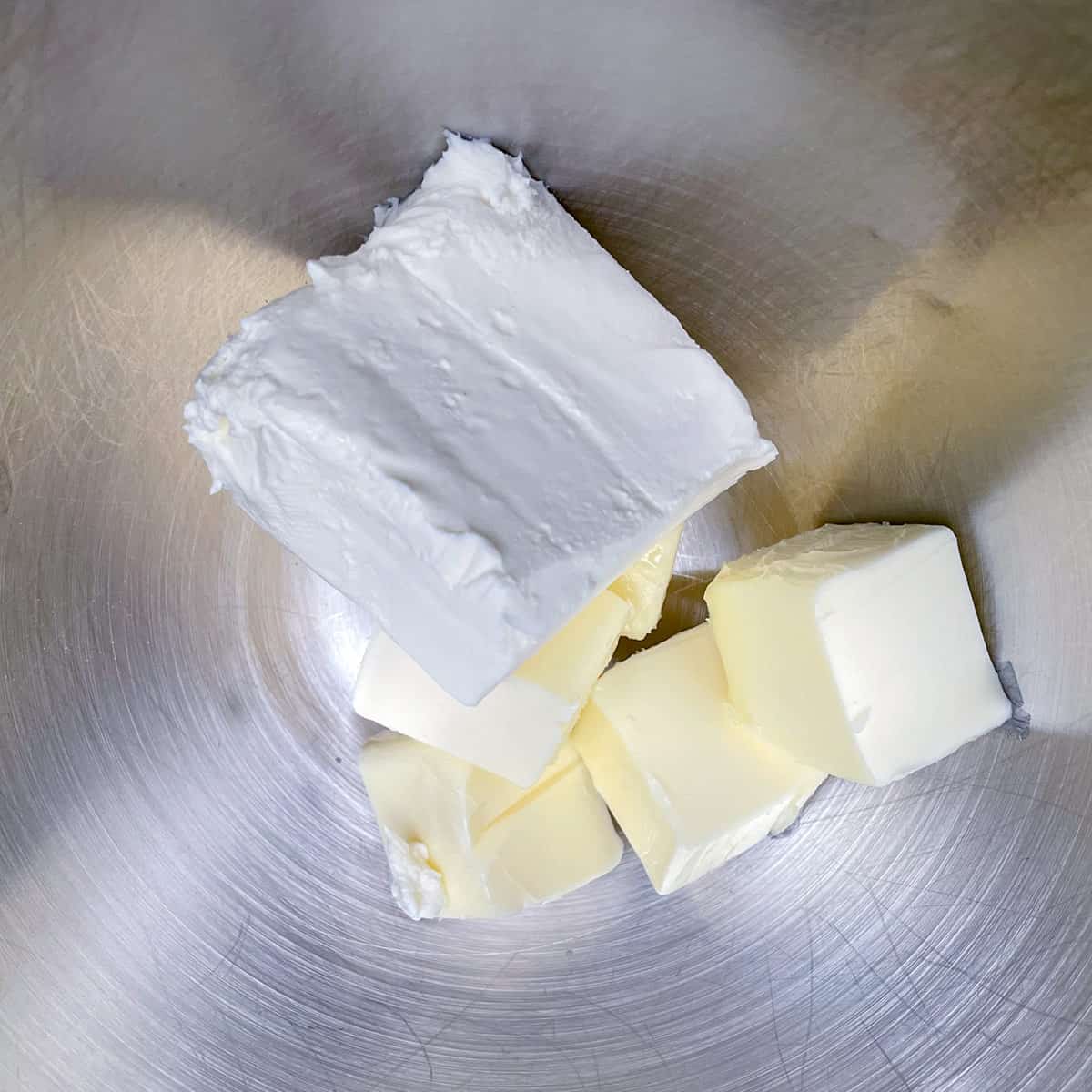 Butter and cream cheese in a mixer bowl/