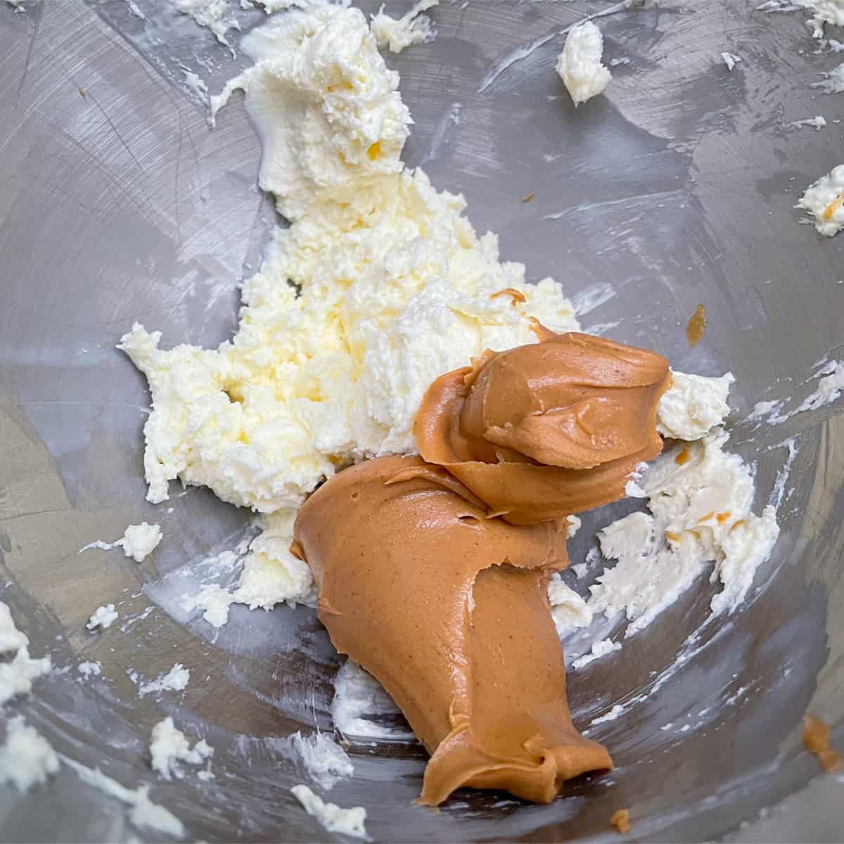 The creamy peanut butter is added to the butter cream cheese.