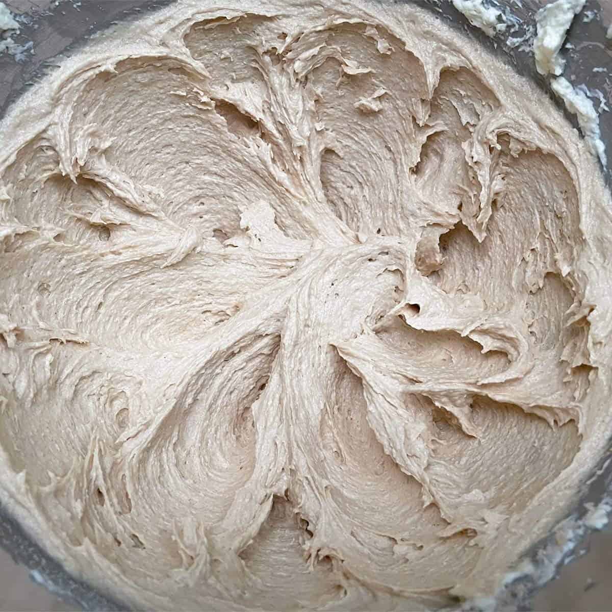 Creamy swirls of butter, cream cheese, and peanut butter after being mixed.