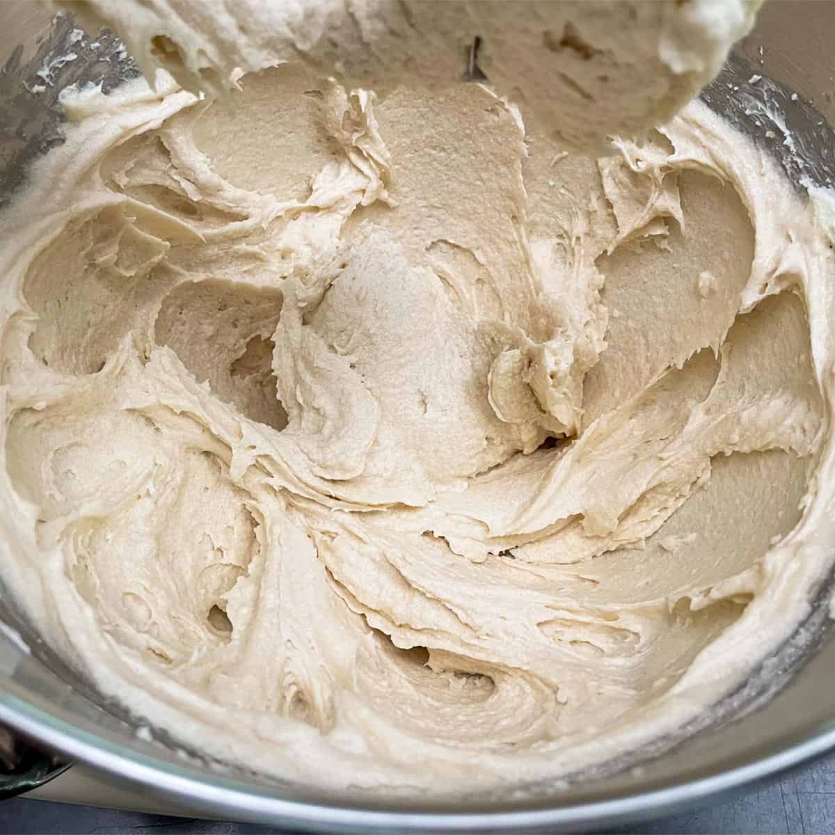 Creamy cookie dough with butter, cream cheese and sugar have been mixed on medium mixer speed.