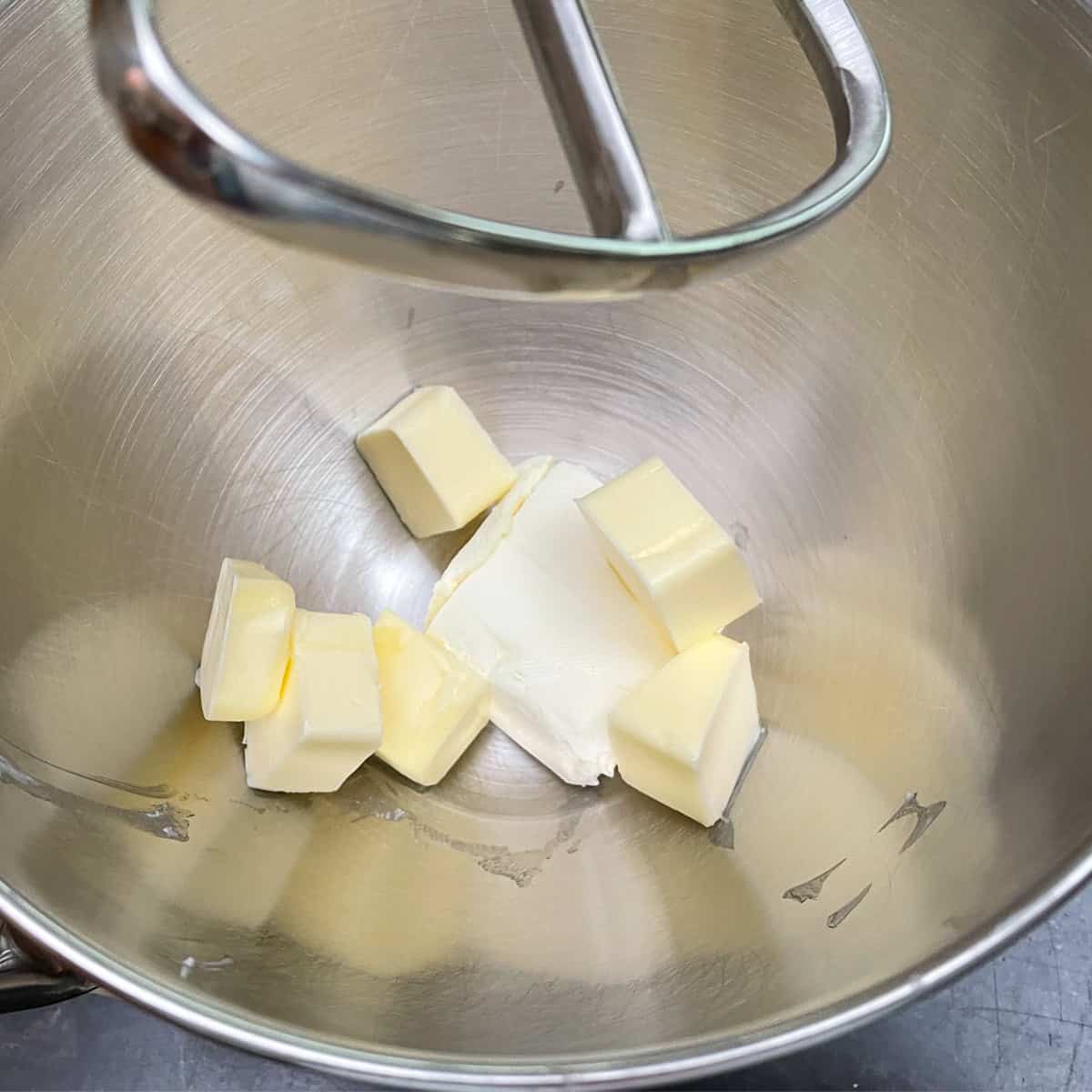 Cream cheese and butter cut into slices ready to be mixed.