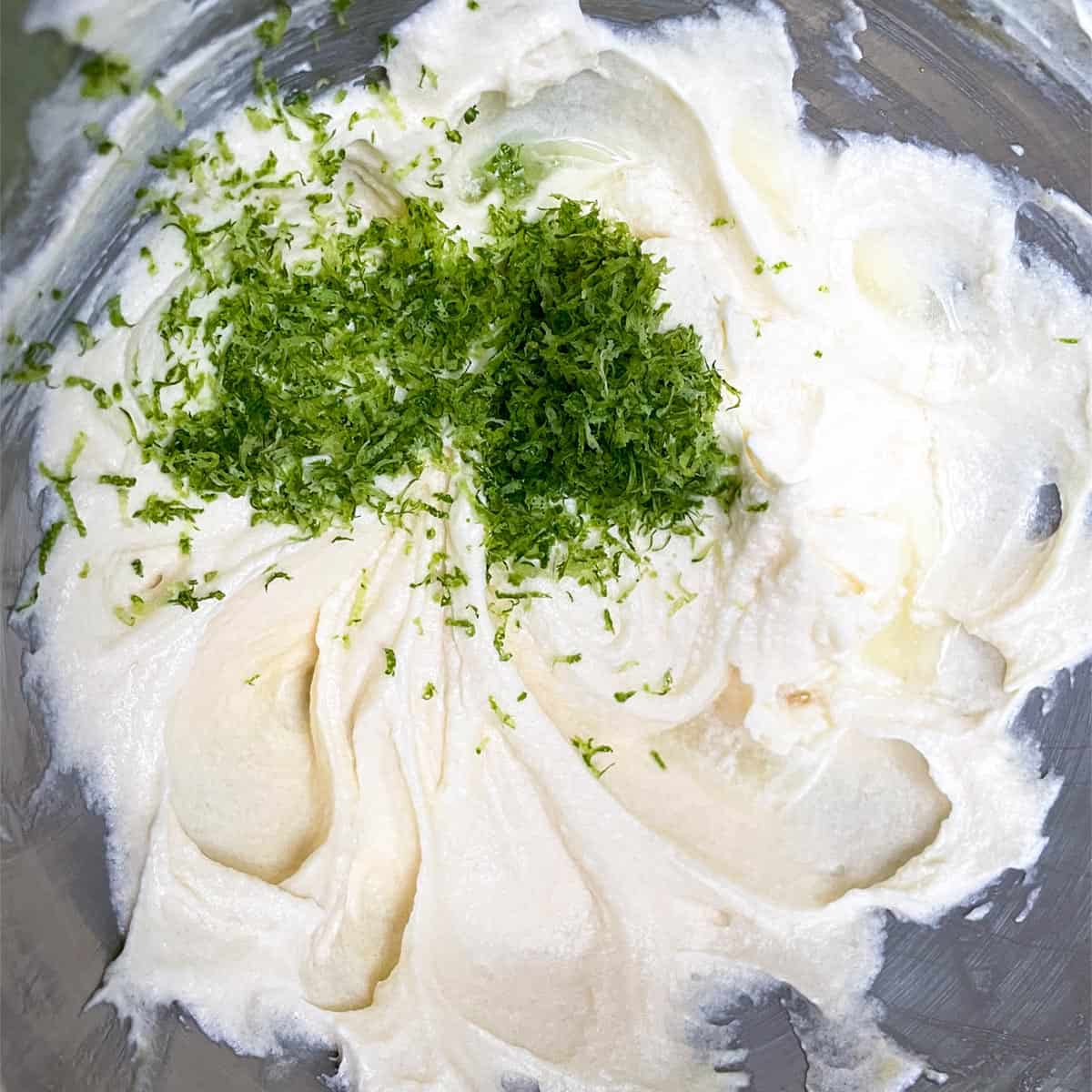 Adding lime zest and juice to cookie dough.