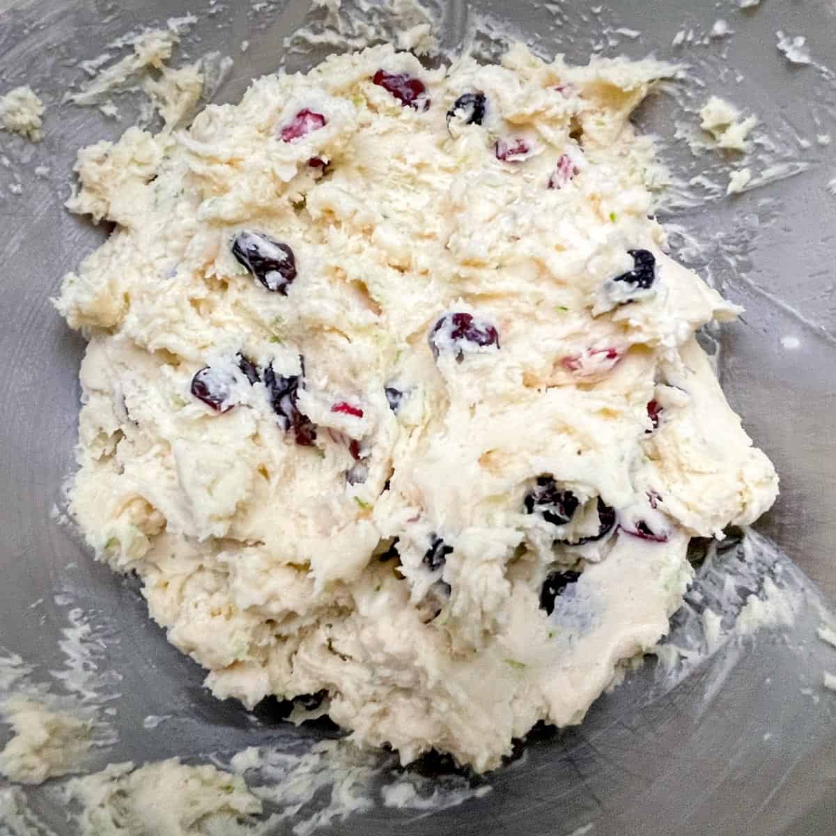Lime with dried fruit and macadamia nut cookie dough completely mixed and ready to be chilled.