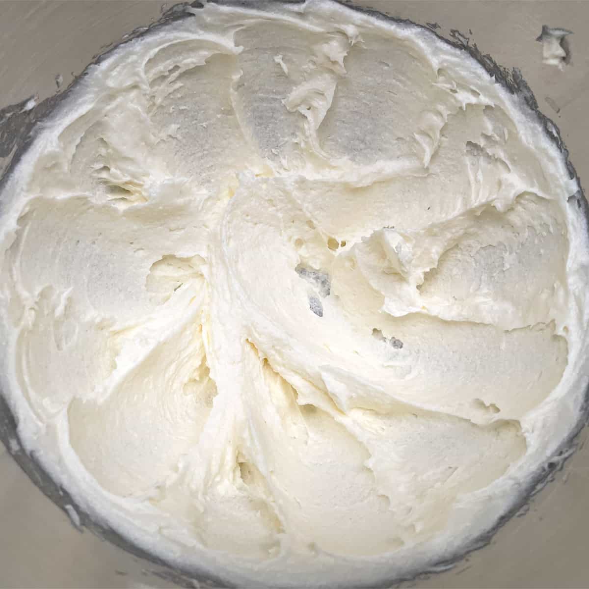 Butter, cream cheese, and sugar with soft peaks after mixing for 2 minutes.