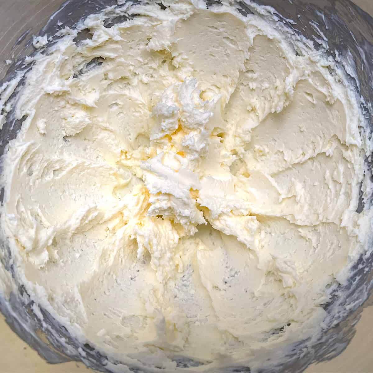 Creamed butter and cream cheese in a mixer bowl.